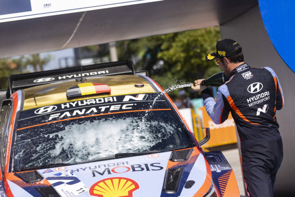 Thierry Neuville spraying champagne onto his Hyundai after winning