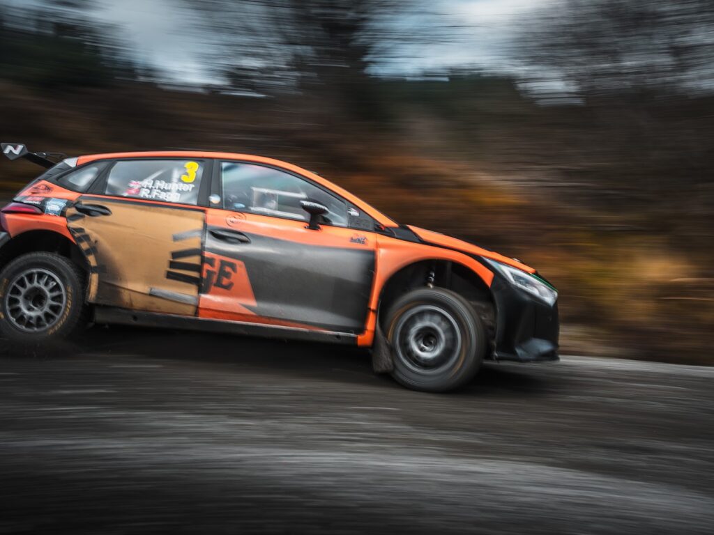 Rally car going quickly around a corner.