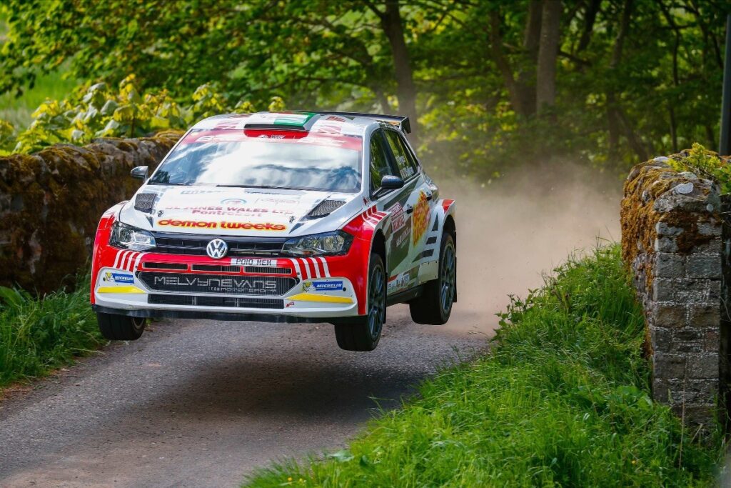 Polo rally car going over a jump.