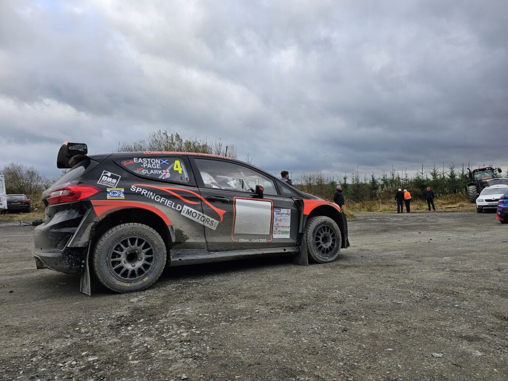 Rally car on gravel road in staging area